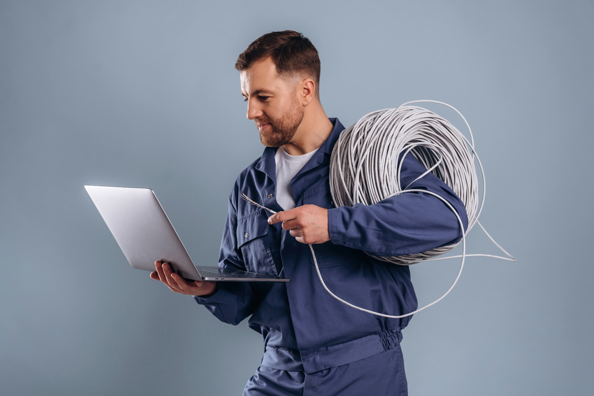 Tradesperson viewing website working effectively on laptop.